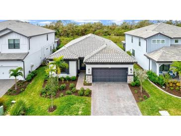 Stunning curb appeal with a well manicured lawn at 16247 Hidden Oak Loop, Bradenton, FL 34211