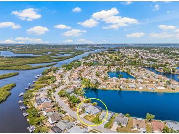 Stunning aerial view of waterfront home, showcasing landscaping and waterfront access at 1228 50Th E St, Bradenton, FL 34208