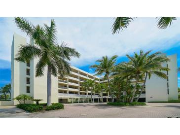 Luxury condo building with tropical landscaping at 1930 Harbourside Dr # 145, Longboat Key, FL 34228