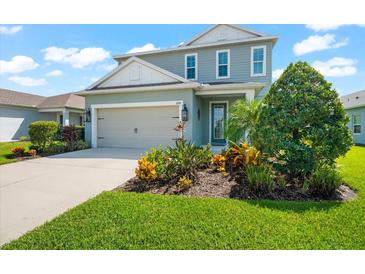 Two-story house with a two-car garage and well-manicured lawn at 4704 Foxtail Dr, Parrish, FL 34219