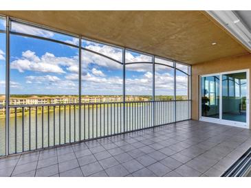 Spacious screened balcony overlooking lake and community at 10530 Boardwalk Loop # 601, Bradenton, FL 34202