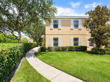 Charming two-story home with a well-manicured lawn and lush landscaping creating an inviting curb appeal at 6205 Triple Tail Ct # 101, Lakewood Ranch, FL 34202