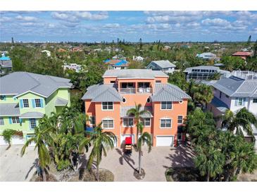 Large two-story home with a gray metal roof and two car garage at 467 Canal Rd # 467, Sarasota, FL 34242
