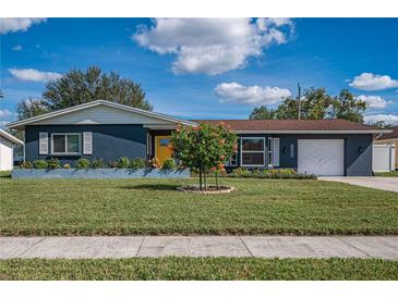 Charming ranch home with a yellow door and manicured lawn at 6947 Antigua Pl, Sarasota, FL 34231