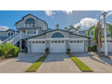 Two-story house with a double garage and lush landscaping at 1328 Siesta Bayside Dr # 1328-C, Sarasota, FL 34242