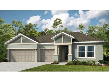 Two-story house with three-car garage and landscaping at 16443 Star Grass Cir, Bradenton, FL 34211