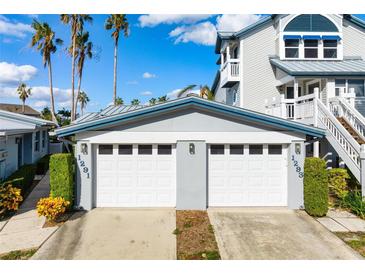 Two-car garage with white doors and gray trim at 1291 Siesta Bayside Dr # 1291A, Sarasota, FL 34242