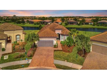 Luxury home with a tile roof and nicely landscaped yard at 4612 Stickley Ct, Palmetto, FL 34221