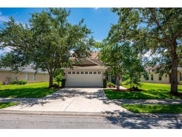 Two-story home with attached garage and landscaped yard at 6227 Blue Runner Ct, Lakewood Ranch, FL 34202