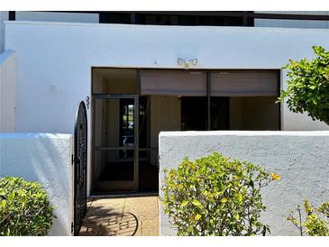 Exterior view of condo with gated entry and landscaping at 3500 El Conquistador Pkwy # 331, Bradenton, FL 34210