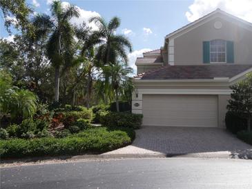 Two-story home with landscaped yard and brick driveway at 5242 Parisienne Pl # 201, Sarasota, FL 34238