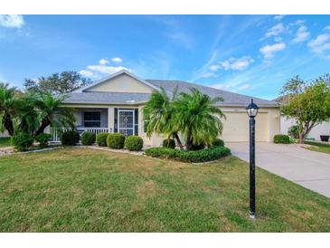 Single-story home with landscaped lawn at 2467 E Del Webb Blvd, Sun City Center, FL 33573