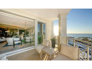 Spacious balcony with ocean view and comfortable seating at 2050 Benjamin Franklin Dr # B704, Sarasota, FL 34236