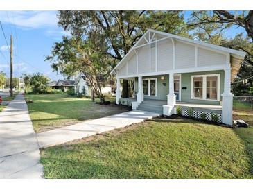 Charming house exterior with a green facade, porch, and well-maintained lawn at 903 W Reynolds St, Plant City, FL 33563