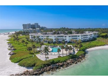 Aerial view of beachfront property with pool at 100 Sands Point Rd # 223, Longboat Key, FL 34228