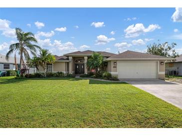 Beautiful house exterior with lush lawn at 23095 Langdon Ave, Port Charlotte, FL 33954
