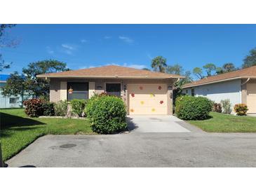 Brick ranch home with attached garage and landscaped yard at 4924 Live Oak Cir # 115, Bradenton, FL 34207