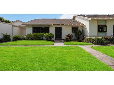 Front view of a condo with well-maintained lawn at 6515 Heritage Ln # 2615, Bradenton, FL 34209