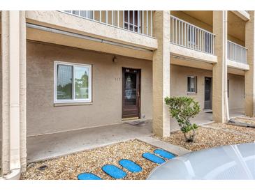 Condo building exterior showcasing entrance and landscaping at 3532 Lake Bayshore Dr # K117, Bradenton, FL 34205