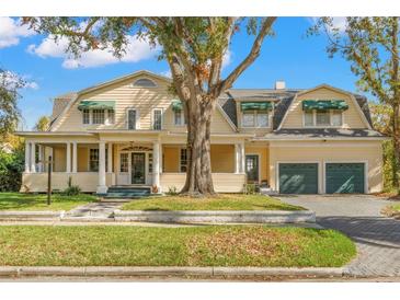 Large two-story home with a wrap-around porch and two-car garage at 810 S Edison Ave, Tampa, FL 33606