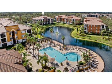 Community resort-style pool with a fountain and plenty of lounge space at 8377 38Th Street E Cir # 308, Sarasota, FL 34243
