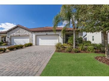 Two-car garage, paver driveway, and landscaped lawn at 2532 Avolet Ct, Lakewood Ranch, FL 34211