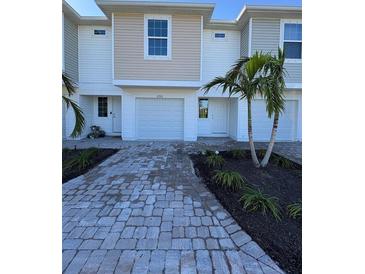 Two-story townhome with attached garage and paved driveway at 2533 6Th Ave Drive E # 2, Bradenton, FL 34208
