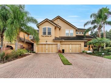 Two-story townhome with double garage and brick driveway at 8277 Villa Grande Ct, Sarasota, FL 34243