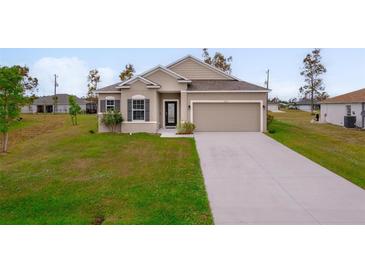 One-story home with a light beige exterior, gray shutters, and a two-car garage at 16531 Becasse Dr, Punta Gorda, FL 33955