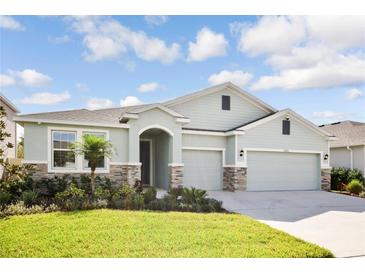 One-story house with a two-car garage and attractive landscaping at 16926 Harvest Moon Way, Bradenton, FL 34211