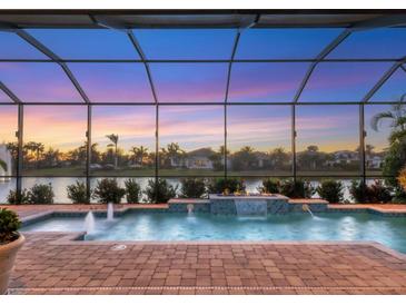 Stunning pool and spa with fire pit at sunset at 5058 Surfside Cir, Lakewood Ranch, FL 34211