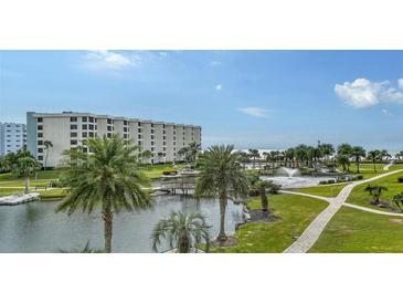 Beautiful waterfront view with a resort-style pool and lush landscaping at 5760 Midnight Pass Rd # 307D, Sarasota, FL 34242