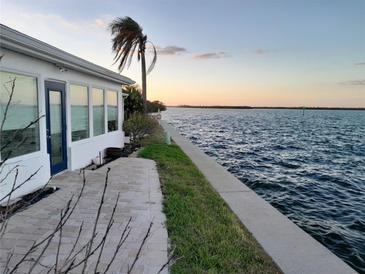 Spacious waterfront patio with brick pavers and water views at 957 Spanish N Dr, Longboat Key, FL 34228