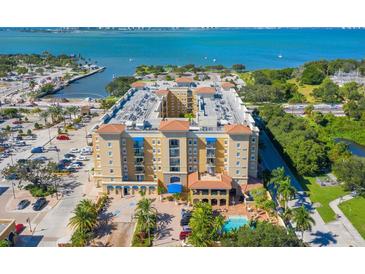 Aerial view of an apartment building with a pool and parking lot at 1064 N Tamiami Trl # 1311, Sarasota, FL 34236