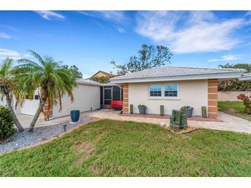 Florida home with landscaped yard, two-car garage, and inviting front porch at 115 Villa Dr # 115, Osprey, FL 34229