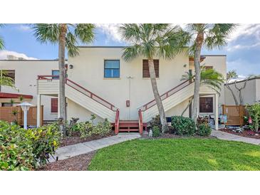 Front view of condo building with stairs and landscaping at 304 Spring Lakes Blvd # 304, Bradenton, FL 34210