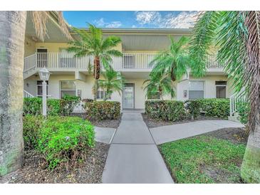 Condo building exterior with landscaping and walkway at 4655 Tower Hill Ln # 2412, Sarasota, FL 34238