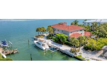 Aerial view of waterfront home with boat lift and dock at 585 Gunwale Ln, Longboat Key, FL 34228