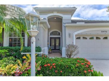 Inviting home exterior featuring a double door entry and lush landscaping at 8496 Idlewood Ct, Lakewood Ranch, FL 34202