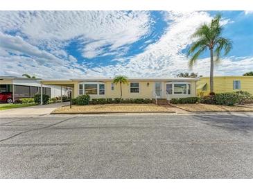 Charming single-story home featuring a covered carport and well-maintained landscaping at 2107 Palma Sola Blvd # 84, Bradenton, FL 34209