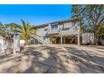 Two-story house with carport and fenced yard at 3511 Camino Real, Sarasota, FL 34239
