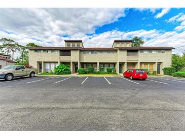 Front view of a townhouse community with parking at 4477 Sandner Dr, Sarasota, FL 34243