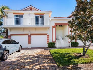 Two-story house with a two-car garage, and a well-manicured lawn at 7335 Fountain Palm Cir # 7335, Bradenton, FL 34203