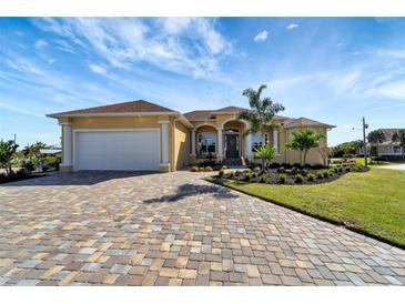 Beautiful waterfront home with paver driveway and landscaping at 118 Creek Se Dr, Port Charlotte, FL 33952