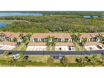 Aerial view of a community of villas with attached garages and lush landscaping at 6705 Grand Estuary Trl # 206, Bradenton, FL 34212