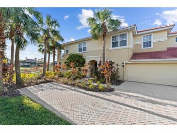 Two-story townhome with attractive landscaping and a paved driveway at 918 River Basin Ct # 101A, Bradenton, FL 34212