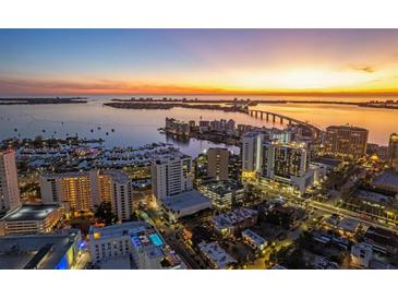 Stunning aerial view of the city skyline at sunset, showcasing the property's prime location at 1335 2Nd St # 301, Sarasota, FL 34236