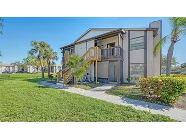 Inviting two-story condo featuring private balconies, wood stairs, and lush landscaping near a tranquil lake at 3609 59Th W Ave # 4045, Bradenton, FL 34210