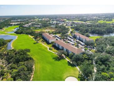 Beautiful aerial view of community condos near a golf course and lush landscaping at 8735 Olde Hickory Ave # 8108, Sarasota, FL 34238