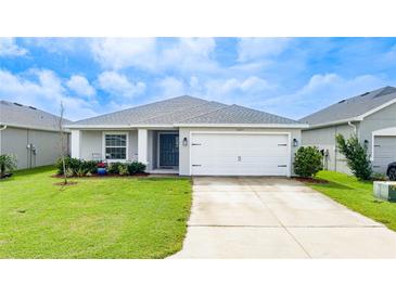 Newly constructed one-story home with a two-car garage and landscaped lawn at 16415 62Nd E Gln, Parrish, FL 34219